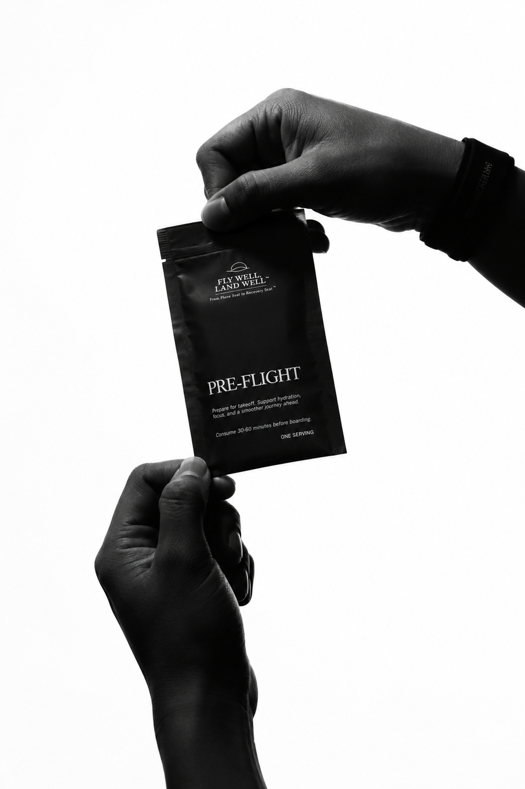 A person's hands holding a black pouch labeled 'PRE-FLIGHT' against a solid white background.