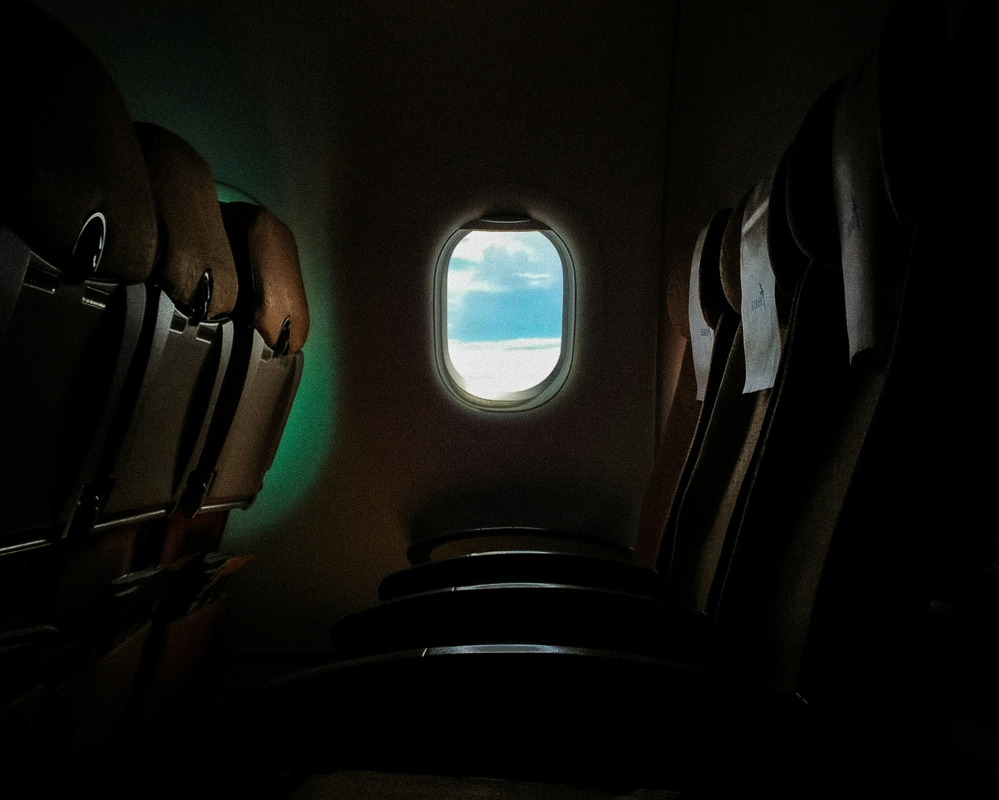 Airplane interior with a window view of clouds